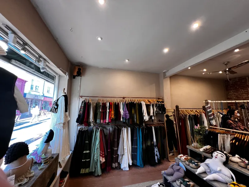 The shop before the work: rails of clothes and shelves on the ground floor, January 2024
