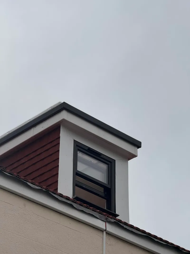 A new dormer window on the replacement roof.