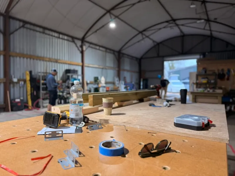 Inside the Tidal Drift workshop near Chailey: a long workbench under the arched roof of a large timber barn.